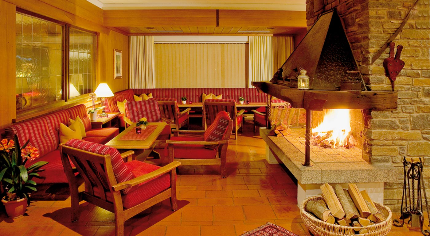 Cosy armchairs in front of the fireplace at the reception